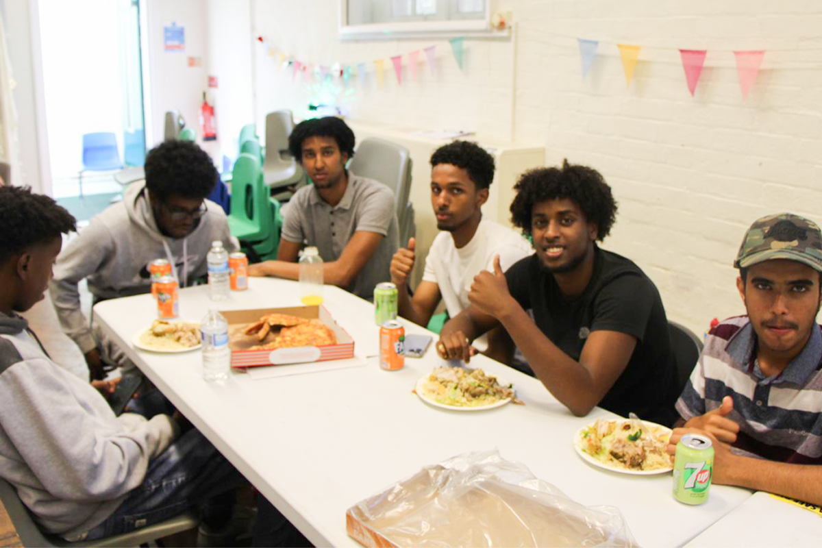 Young people sharing a community meal together